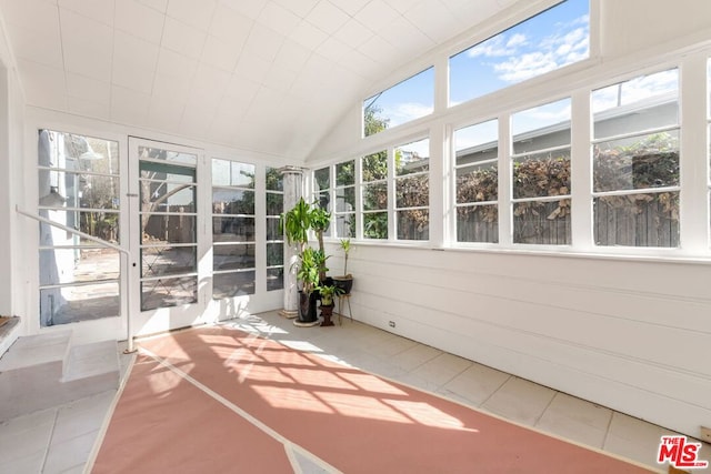 unfurnished sunroom with lofted ceiling