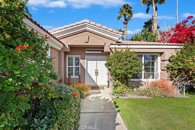 doorway to property with a yard