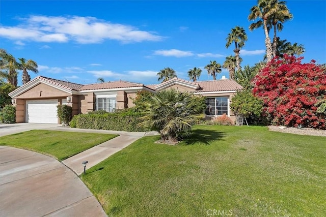 view of front of property with a front yard and a garage