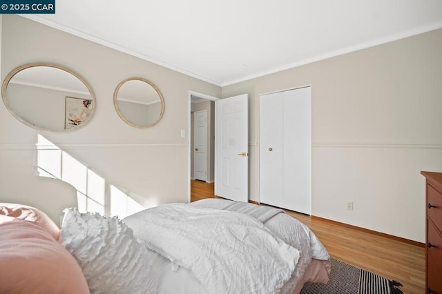 bedroom with ornamental molding and light hardwood / wood-style flooring