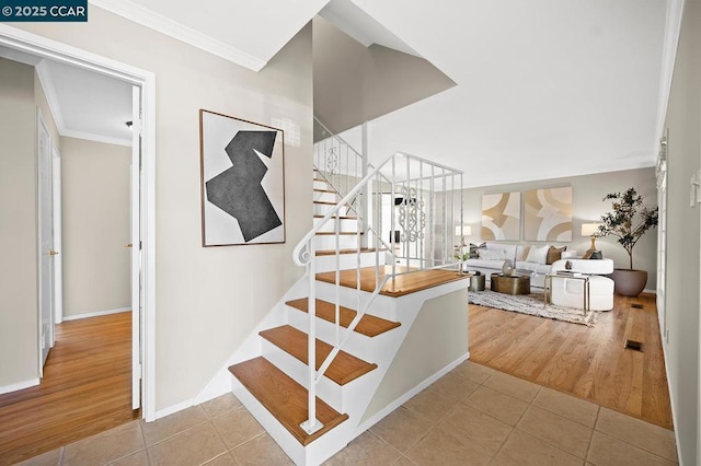 stairs with tile patterned flooring and ornamental molding