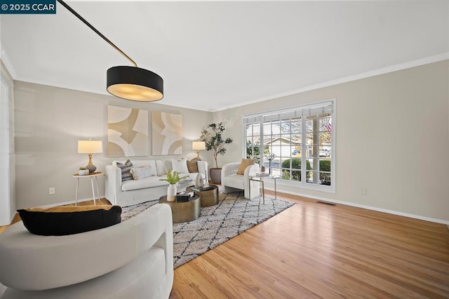 living room featuring ornamental molding and hardwood / wood-style flooring