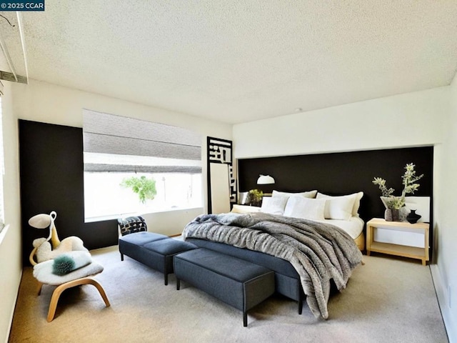 bedroom featuring a textured ceiling and carpet flooring