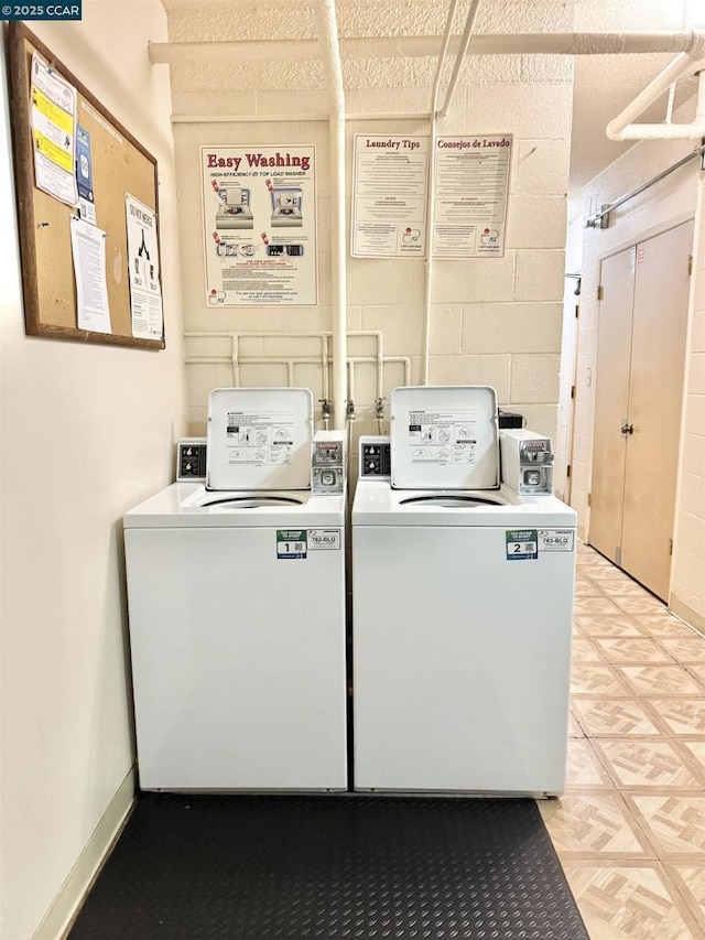 washroom with washing machine and clothes dryer