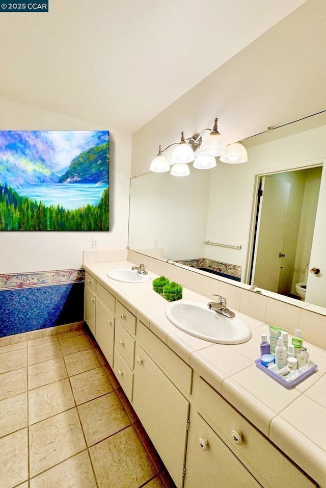 bathroom featuring toilet, vanity, and tile patterned flooring