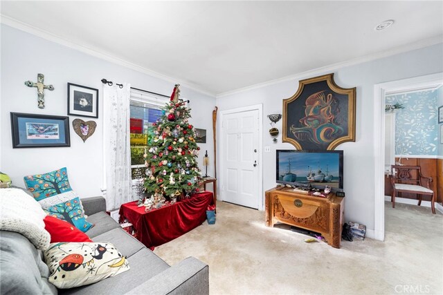 carpeted living room featuring ornamental molding