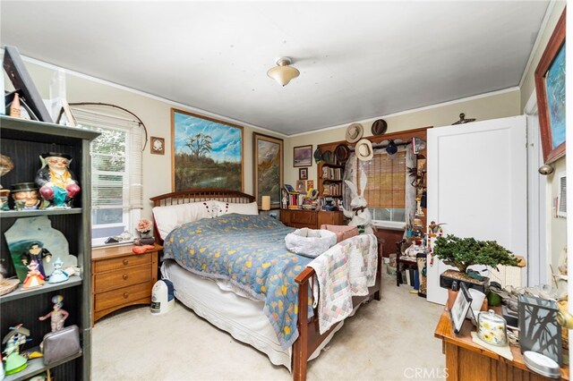 carpeted bedroom with ornamental molding