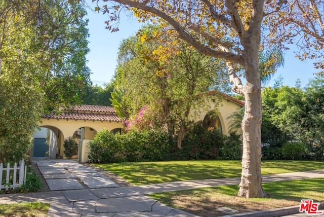 mediterranean / spanish-style house with a front lawn