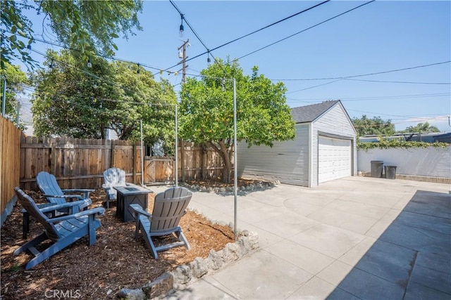 view of patio featuring a garage and an outbuilding