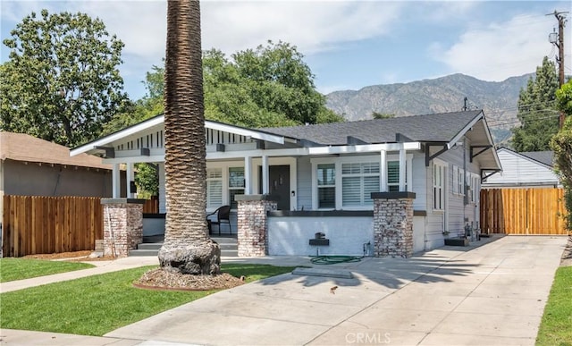 view of front facade with covered porch and a mountain view