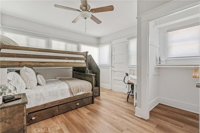 bedroom with ceiling fan and light hardwood / wood-style floors