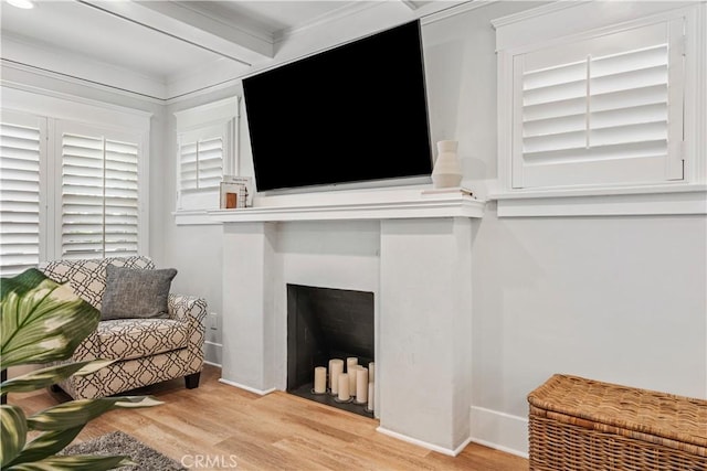 living room featuring light wood-type flooring and beamed ceiling