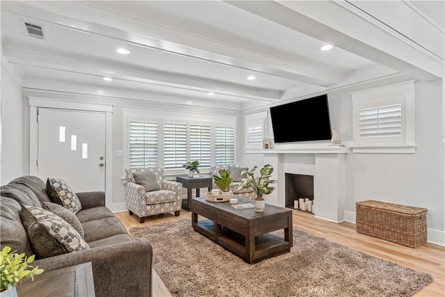 living room featuring hardwood / wood-style floors and beamed ceiling