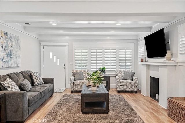 living room with light hardwood / wood-style floors and beam ceiling