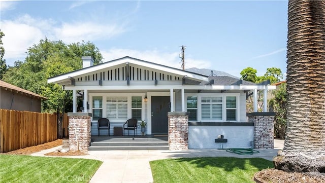 craftsman-style house with a porch and a front lawn