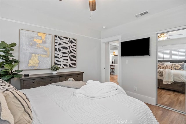 bedroom with ceiling fan and light hardwood / wood-style floors