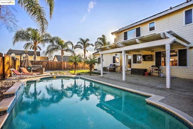 view of swimming pool with a patio area and grilling area