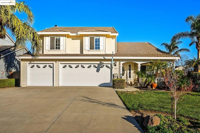 view of front property with a garage and a front yard