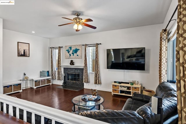 living room with a fireplace, hardwood / wood-style floors, and ceiling fan