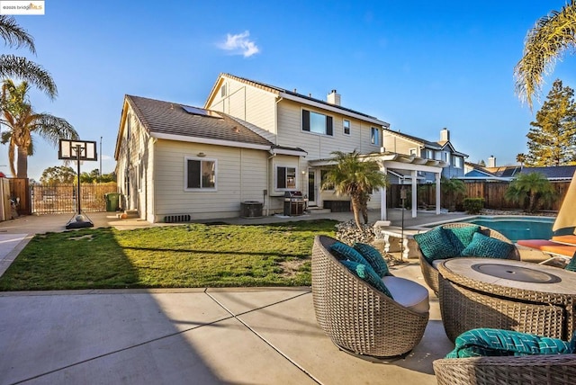 rear view of house featuring a lawn, a pergola, a patio, outdoor lounge area, and a fenced in pool