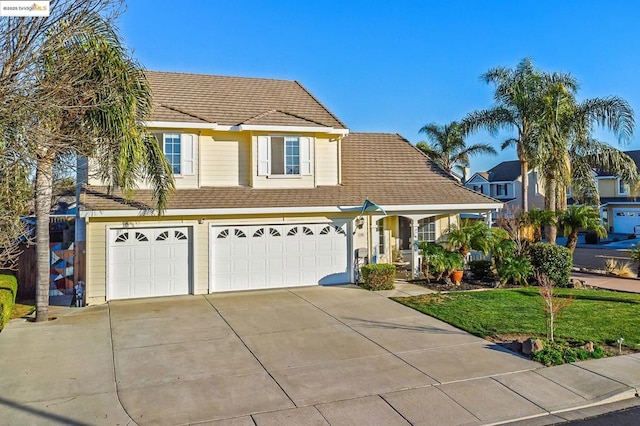 view of front of property featuring a garage and a front yard