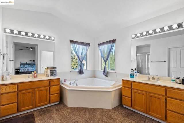 bathroom with vanity, vaulted ceiling, and plus walk in shower