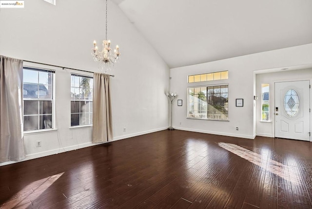 entryway featuring high vaulted ceiling, dark hardwood / wood-style flooring, and a chandelier