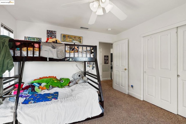 carpeted bedroom featuring a closet and ceiling fan