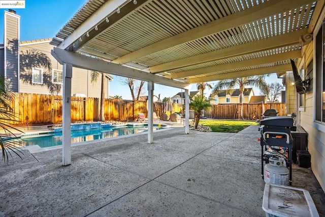 view of patio with area for grilling and a fenced in pool