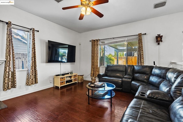 living room featuring ceiling fan, a wealth of natural light, and dark hardwood / wood-style floors