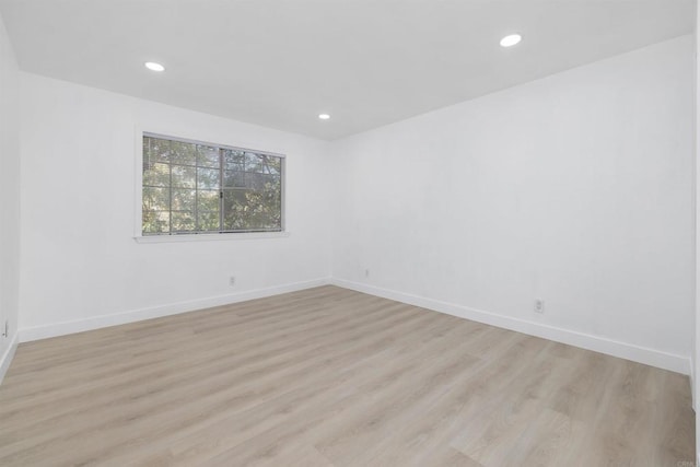 unfurnished room with light wood-type flooring