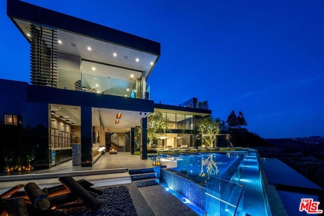 pool at night with a patio