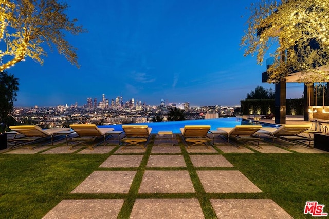 pool at dusk with a lawn