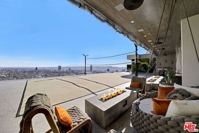 view of patio / terrace featuring ceiling fan and a fire pit