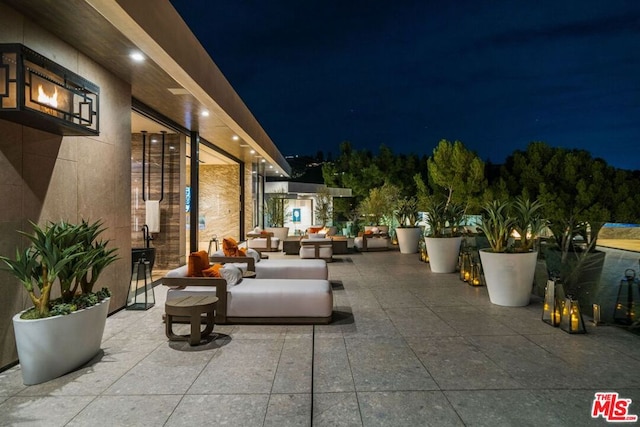 patio at twilight featuring outdoor lounge area