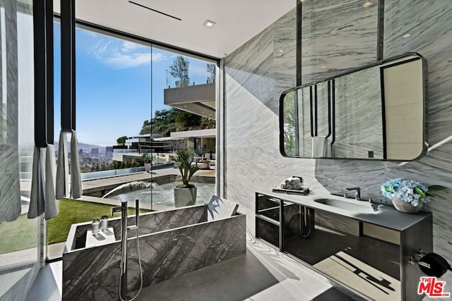 interior space with floor to ceiling windows, backsplash, and vanity