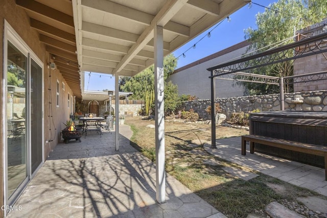 view of patio / terrace with a hot tub and a pergola