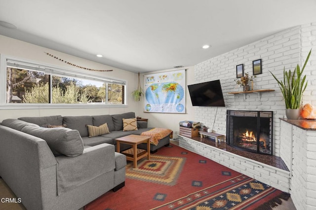 living room featuring a brick fireplace