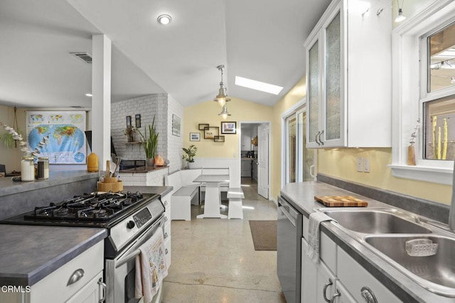 kitchen featuring white cabinetry, lofted ceiling with skylight, and stainless steel appliances