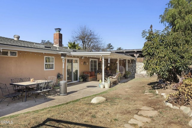 rear view of property featuring a patio