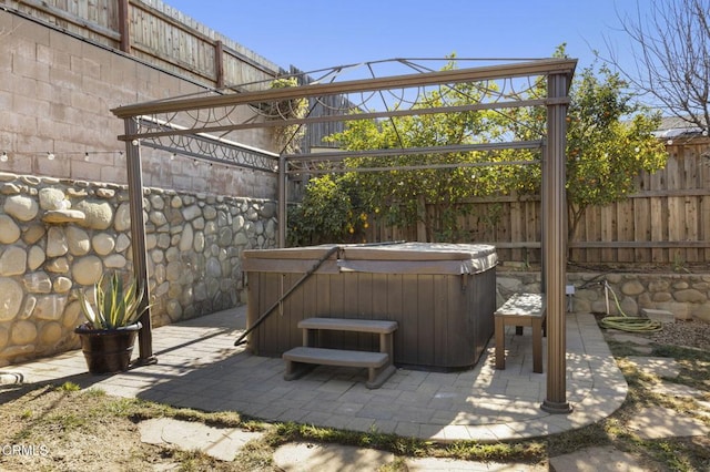 view of patio / terrace with a hot tub