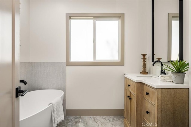 bathroom with vanity and a bathtub