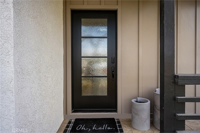 entrance to property featuring stucco siding