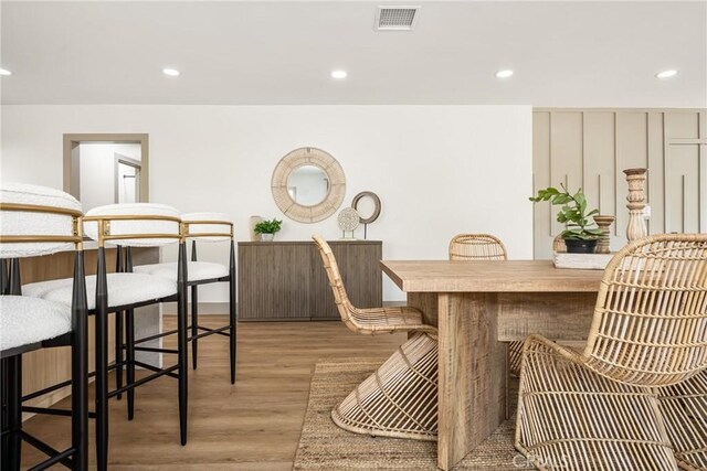 dining space with light wood-type flooring, visible vents, and recessed lighting