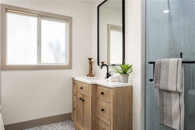 full bathroom with a shower stall, vanity, and baseboards