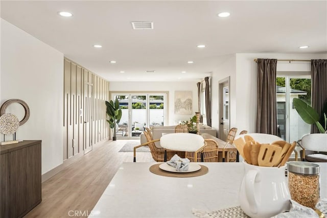 dining room featuring light wood-style flooring, visible vents, and recessed lighting