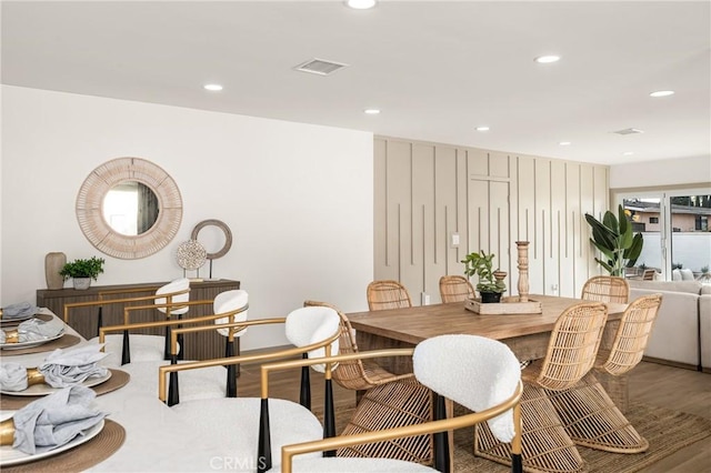 dining area with wood finished floors, visible vents, and recessed lighting