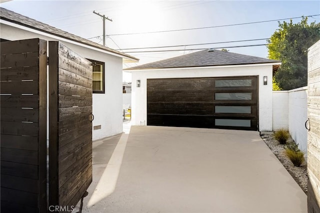 detached garage featuring fence