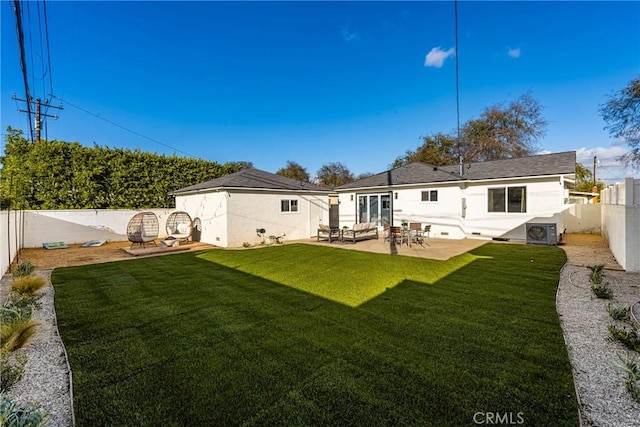 rear view of property featuring a yard, a patio area, a fenced backyard, and central air condition unit