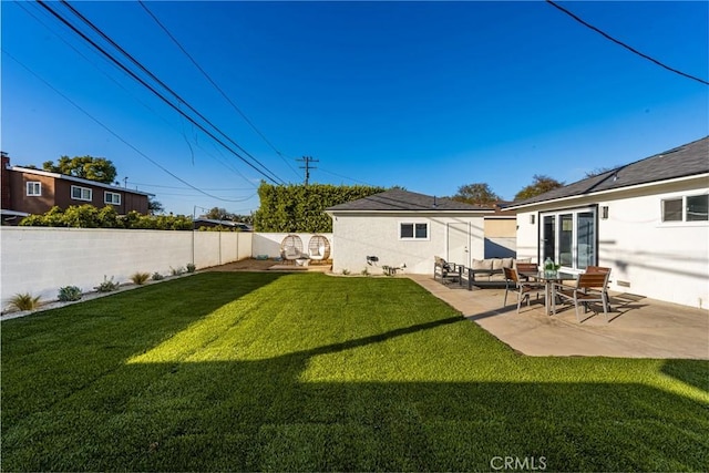 back of property featuring a yard, a patio, an outdoor living space, and fence